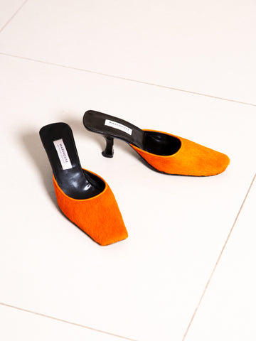 Vintage Y2K bright orange pony hair square-toe mules.
