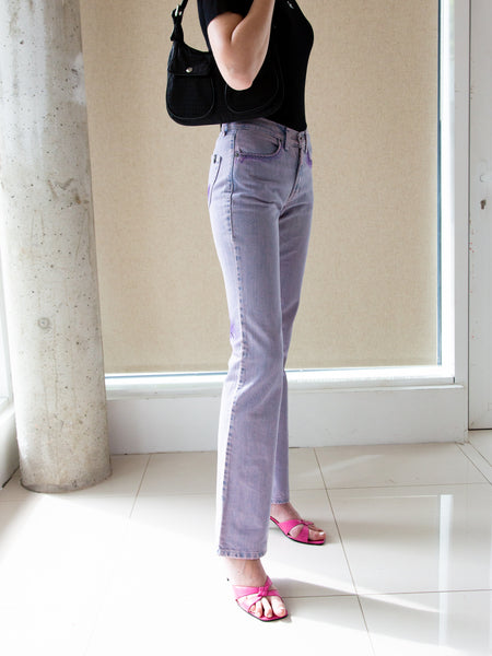 Woman wearing vintage 2000s lilac overdyed jeans with faux 'visible mending' detailing
