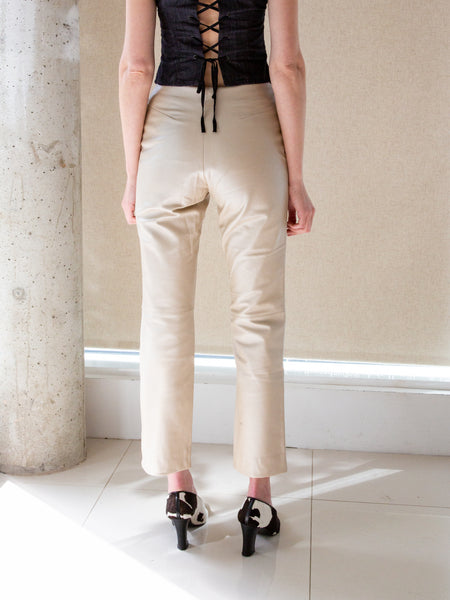 Woman wearing vintage 1990s beige leather trousers with subtle sheen