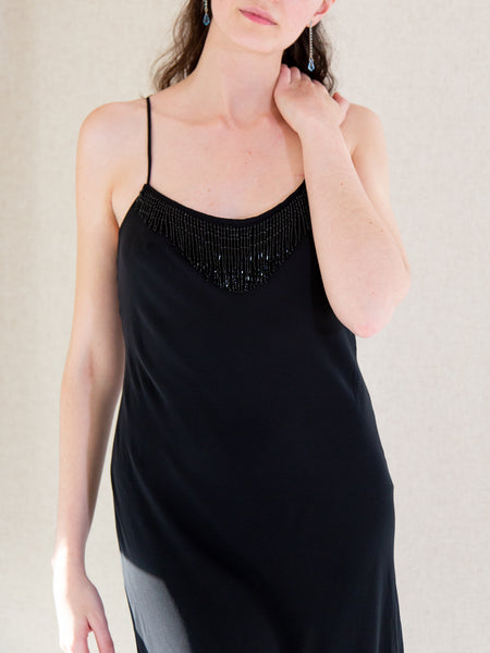 Woman wearing vintage Y2K black sleeveless evening dress by Frank Usher