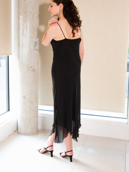 Woman wearing vintage Y2K black sleeveless evening dress by Frank Usher
