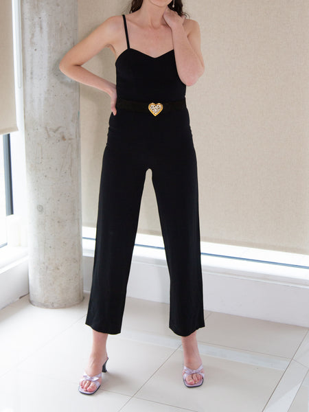 Woman wearing vintage 1990s black sleeveless jumpsuit by Synonyme de Georges Rech