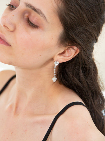 Model wearing a pair of vintage 1980s heart-shaped diamanté drop earrings