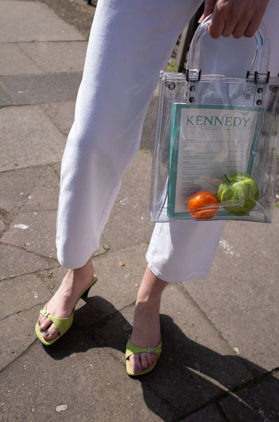 Rosalind Jana wears white vintage Escada jeans with lime-green mules and see-through Suzy Smith bag for Human Sea Vintage