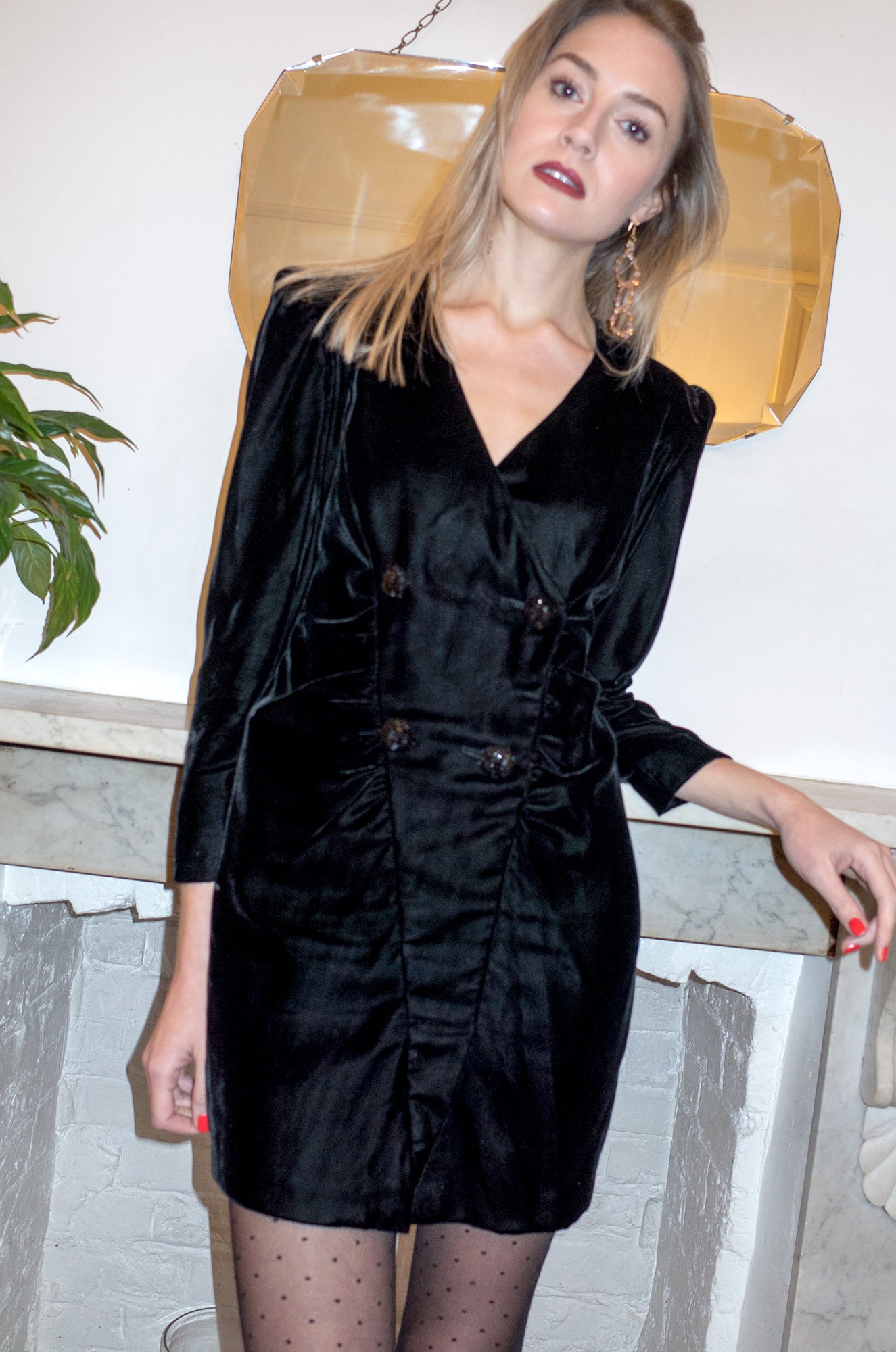 Model wears vintage 1980s black silk velvet long sleeve mini cocktail dress