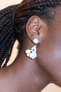 Model wears white vintage 1960s glass earrings