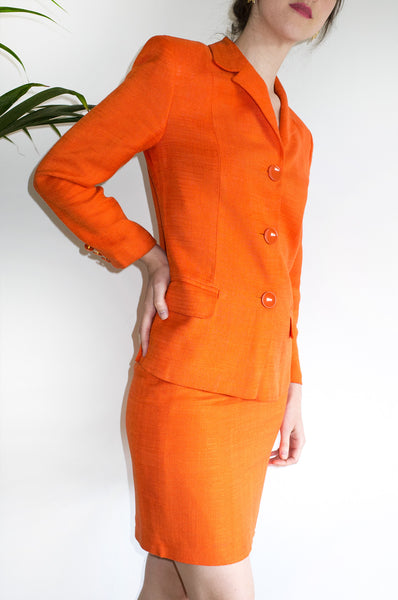 A vintage 1990s orange Italian designer skirt suit by C'est Comme Ca