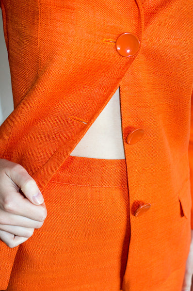 A vintage 1990s orange Italian designer skirt suit by C'est Comme Ca
