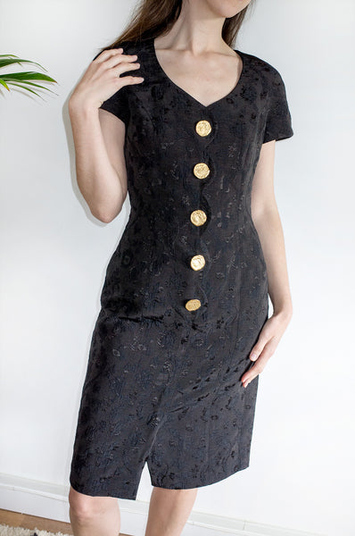 A vintage 1980s black fitted formal dress with scalloped detailing at front and oversized gold buttons