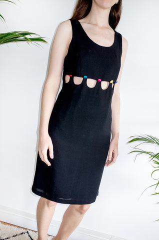 An unusual vintage 1990s black sleeveless shift dress with multicoloured buttons and cutaway detailing.