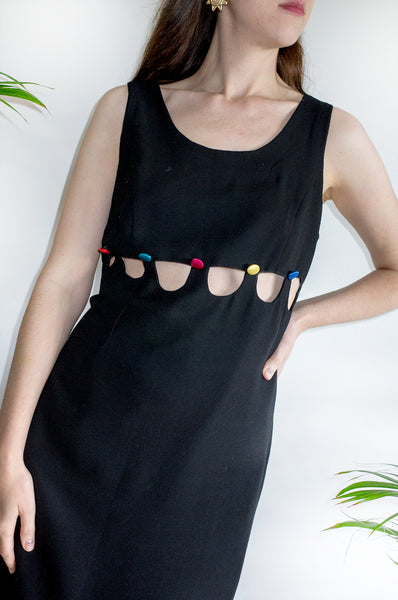 An unusual vintage 1990s black sleeveless shift dress with multicoloured buttons and cutaway detailing.