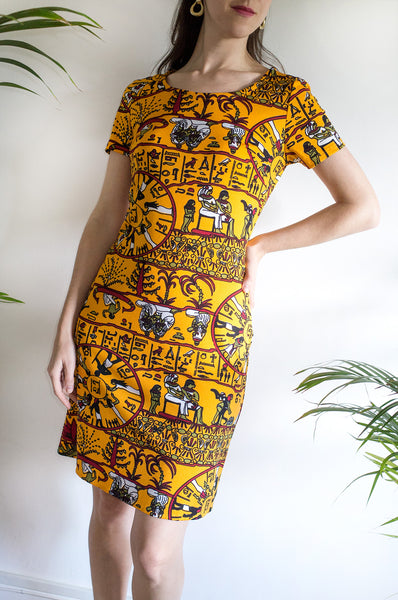 A rare vintage 1970s T-shirt dress featuring a novelty Egyptian hieroglyphics-inspired print.