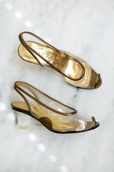 A stunning pair of vintage gold and bronze slingback shoes with sunflower detail and clear plexiglass heels by Libra shoes