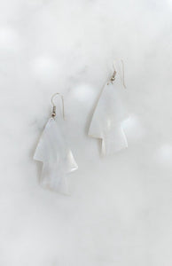 Mother-of-pearl shell earrings with engraved zigzag design and silver-tone wire fastening.