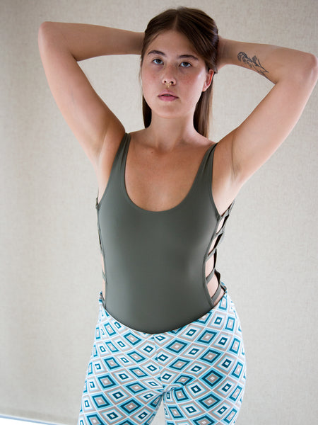 Model wearing vintage Y2K geometric-print flared trousers with elasticated waist