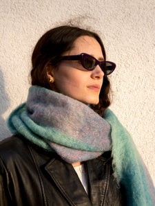 Woman wearing vintage 1960s purple narrow cat-eye sunglasses.